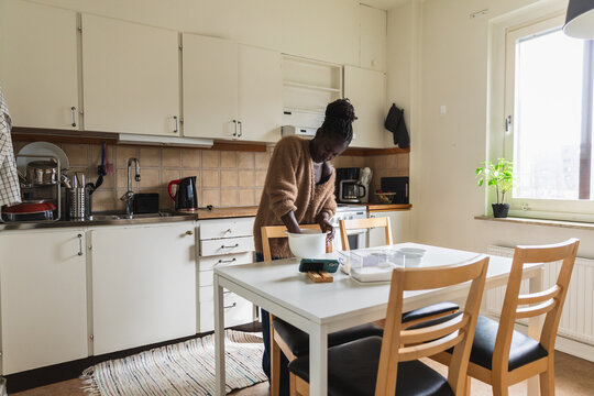 Woman Mixing Ingredients in Bowl while Baking at Home
