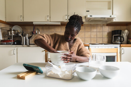 Young Black Woman Mixing Dough and Following Recipe