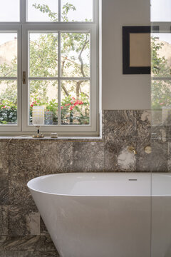 Bathtub by window with soft natural light