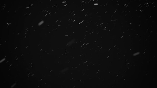 Snowflakes drift down slowly against a dark background. The steady fall creates a winter atmosphere perfect for holiday settings or seasonal themes