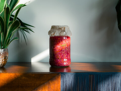 Jar of Fermented Cabbage Sitting on a Wooden Counter