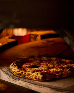Rustic Artisan Pizza in Wood Fired Oven With Glowing Flames