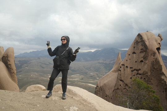 Hiker Enjoys Time on Rocky Mountain Top in Cloudy Weather