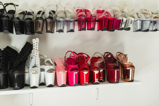 Collection of colorful pole dance high heels on shelves