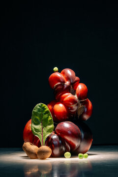 Fresh Vegetables and Fruits Piled on a Table at Night