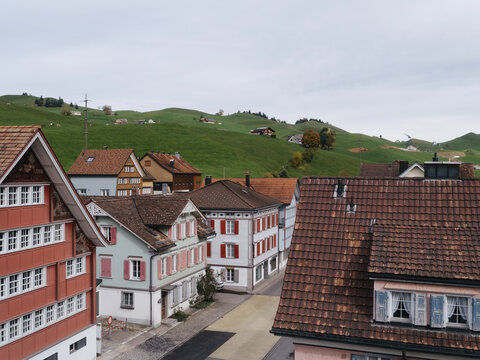 Traditional Swiss Village Architecture And Rolling Green Hills U