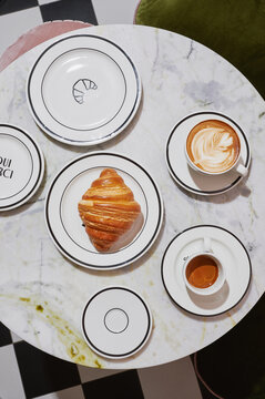 Tabletop view of coffee and croissant on the table