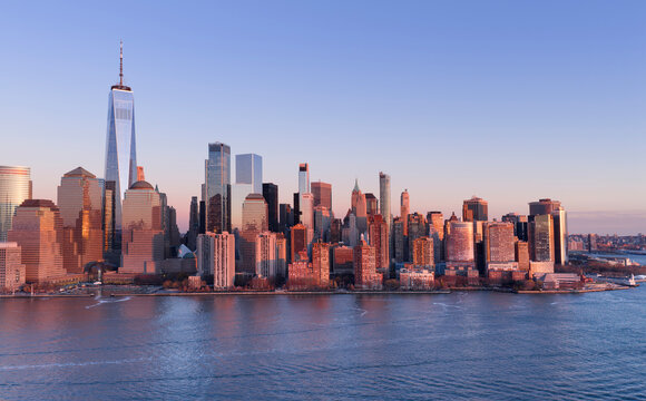NYC aerial cityscape. New York City Hudson skyline at sunset. New York sunset metropolis. NYC panoramic view of Lower Manhattan skyline at sunset. New York City aerial skyline at sunset.