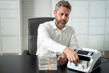 Fototapeta premium Banker counting cash at his office desk. Office banker worker managing money at work. Accountant checking currency. Financial success. Banker organizing banknotes. Man Banker counting money at office.
