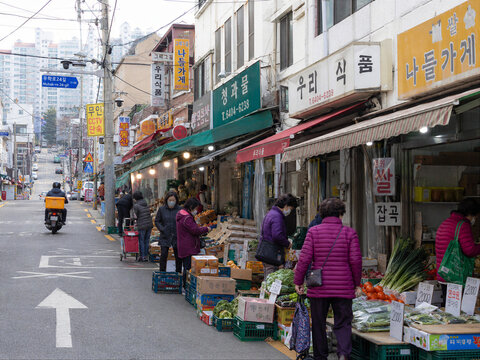 Neighborhood Grocery Storefront on Dense City Street
