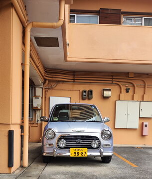 Naha, Japan - May 27, 2026. Front View of Silver Retro Car Daihatsu Mira Gino