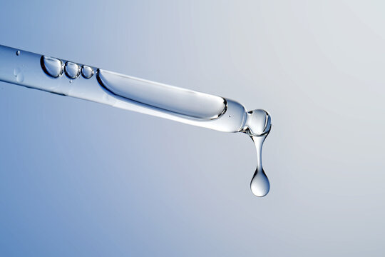 Dropping hyaluronic acid serum from a pipette