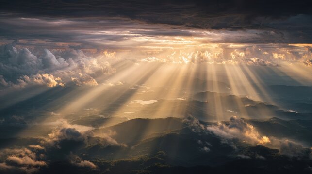Light shines through the clouds over mountains and valleys, creating a powerful feeling of faith and hope in a dramatic setting.
