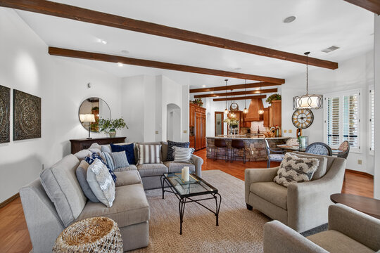 Spacious living room with open kitchen and wooden beams