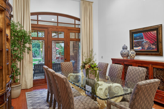 Elegant dining room with glass table and wood accents