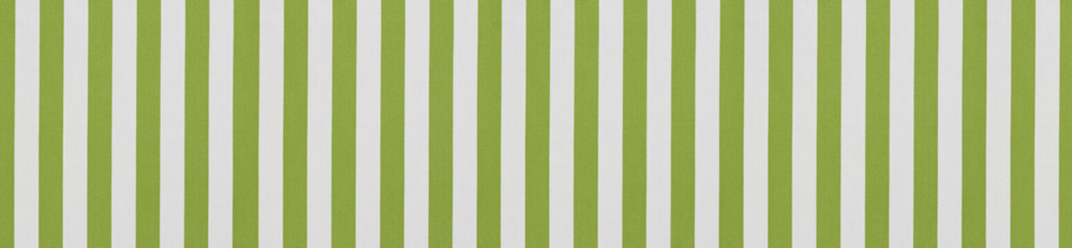 Seamless pattern of vertical light green and white textile stripes on textured awning canvas fabric background