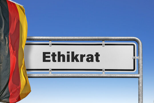 Symbolischer Metalltafel mit der Beschriftung "Ethikrat" und deutscher Flagge im Hintergrund, (Symbolbild)