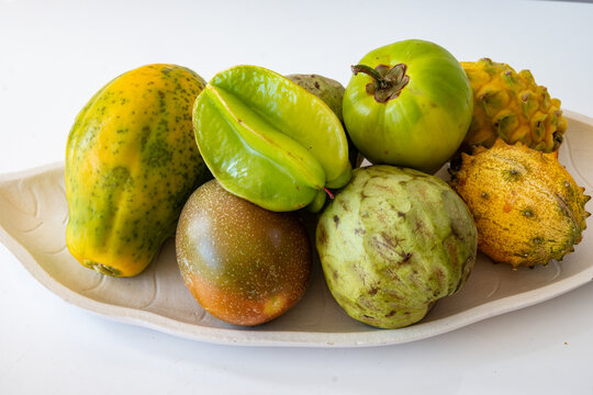 Variety of exotic fruits like cherimoya, dragon fruit, budda's hand, star fruit, papaya, bananas growing on tropical Canary islands, Spain