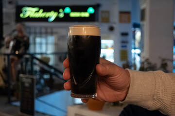 Evening in Irish pub with glasses of dark stour and ale beer, winter vacation on Tenerife, Spain © barmalini