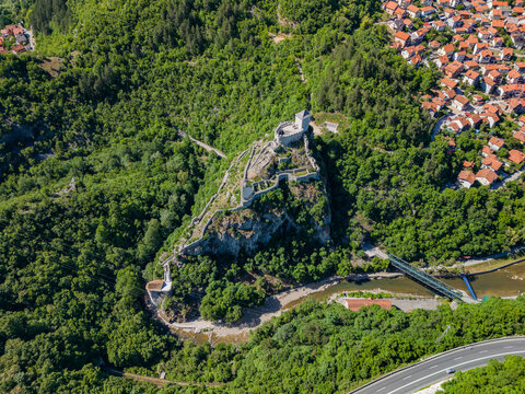 Ancient fort on hill overlooking Uzice town in Zlatibor District of Serbia surrounded by greenery and road