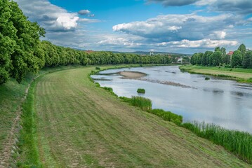 Obraz premium Beautiful scenic river landscape winding through green city park embankment