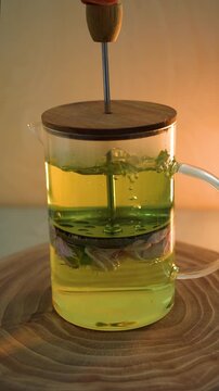 Brewing rose tea in a teapot with a press