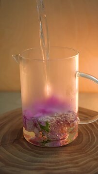 Brewing roses in a glass teapot