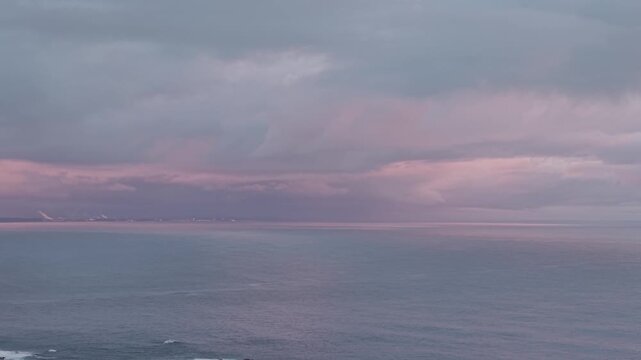 Aerial View of a Purple Sunset Over the Ocean with Dramatic Evening Sky