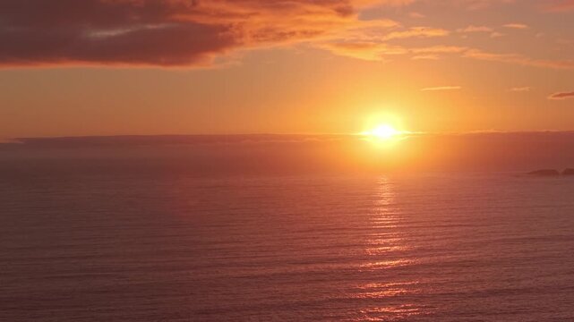 Aerial Sunset Over the Pacific Ocean with Dramatic Clouds and Golden Light