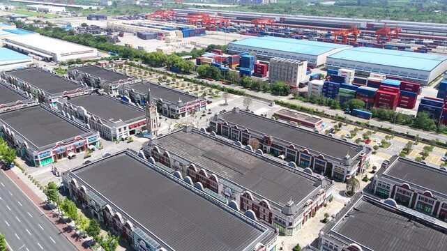 Aerial drone footage of modern industrial and commercial complex with shipping containers and traditional-style buildings in Ningbo, China