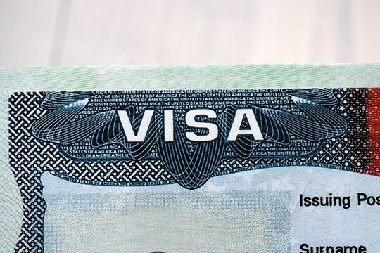 Visa header on sticker in page of biometrical passport. United States visa text and white table