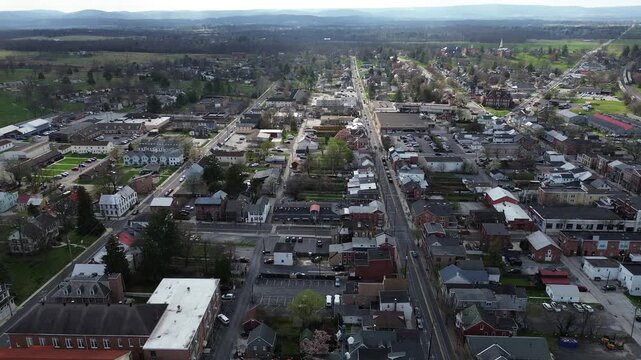 Baltimore Pike corridor stretches toward open farmland south of Gettysburg with scattered commercial sites, neighborhood blocks merging near boundary. Mixed roofing, muted siding form, PA