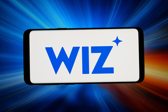 Stuttgart, Germany - 06-08-2026: In this photo illustration, the logo of cloud security company Wiz Inc. is displayed on a smartphone in front of abstract background on computer screen.