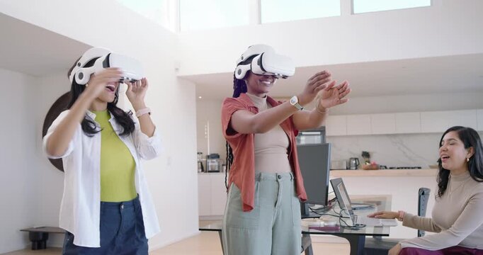 Diverse women coworkers following colleague cueing, using VR headsets, high-fiving in home office