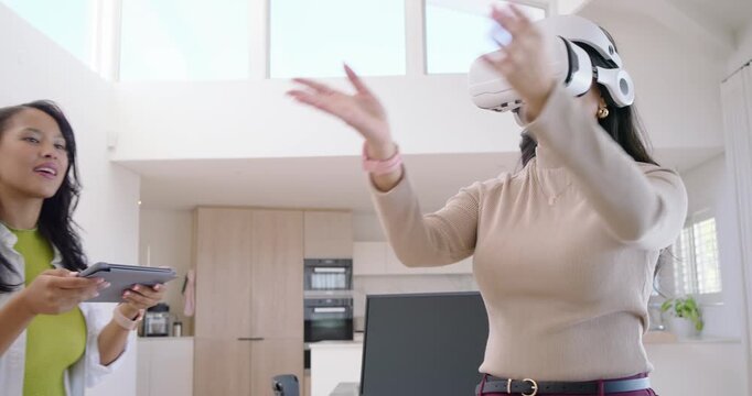 Diverse female user using white VR reaching, pinching while instructor with tablet guiding at home