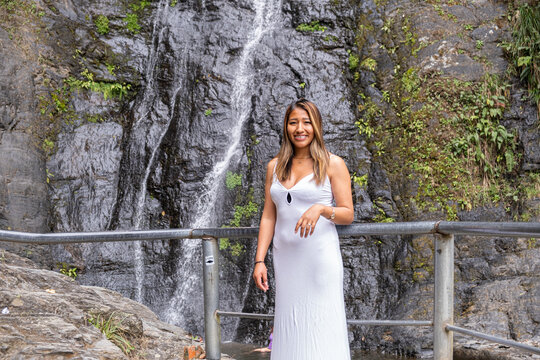 A Bolivian Latina woman at a waterfall in the village of Coroico in the Yungas region of Bolivia - the concept of nature