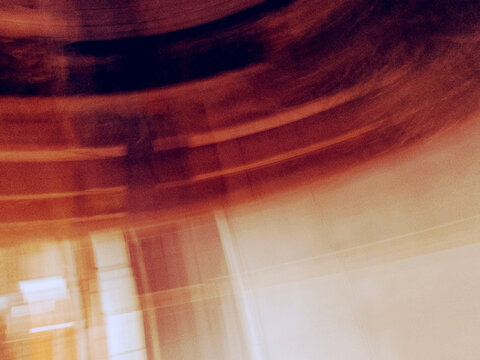Abstract motion blur background, intentional camera movement icm with warm orange and brown tones, dynamic panning streak light texture, artistic overlay