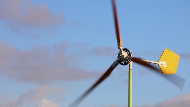Close uo shot of wind farm  against the background of blue sky.