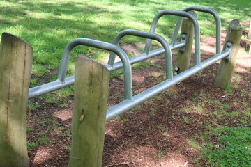Outdoor climbing and play equipment stands in a green recreational area in Heerhugowaard, North Holland. The scene shows modern public playground facilities surrounded by grass and natural greenery. © Fullip