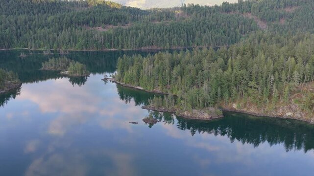 Scenic Drone Shot of Harrison Lake, British Columbia, Featuring Lush Forests and Serene Water
