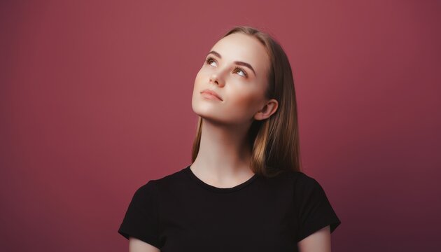Young woman with thoughtful expression against solid pink background