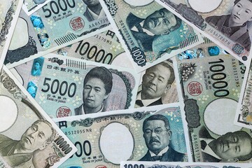 Japanese yen money bills in pile on table. Japan JPY currency cash close up © Viktor