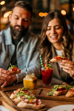 Couple enjoying appetizers and drinks at a restaurant