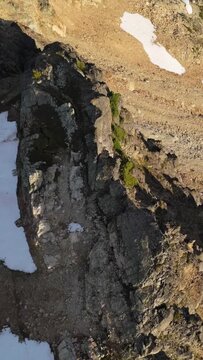 Majestic Aerial View of Rugged Mountainous Terrain with Snow Patches in British Columbia, Canada