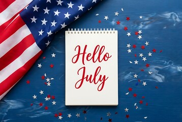 Obraz premium American flag and notebook with hello july text and star confetti on blue wooden background representing american holidays and independence day celebration.