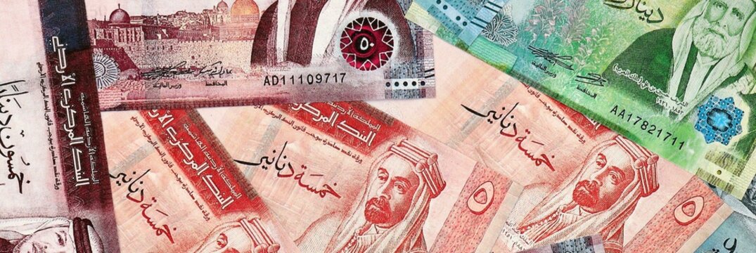 Jordanian dinar money bills in pile on table. Jordan JOD currency cash close up