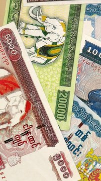 Myanmar kyat money bills in pile on table. Myanmar MMK currency cash close up