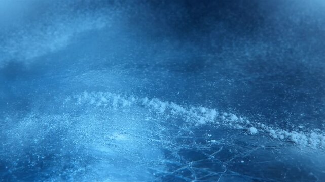 Slow panning shot of icy lake surface with frost and cracking patterns revealing snow drift and texture in cold winter environment