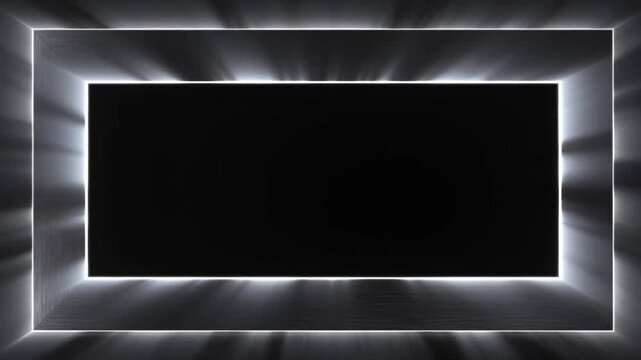 Panning shot of illuminated metal rectangular frames with shifting radial light rays across dark studio backdrop, slow reveal of brushed steel edges