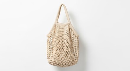 Fototapeta premium Beige knitted string shopping bag with inner lining isolated on white background